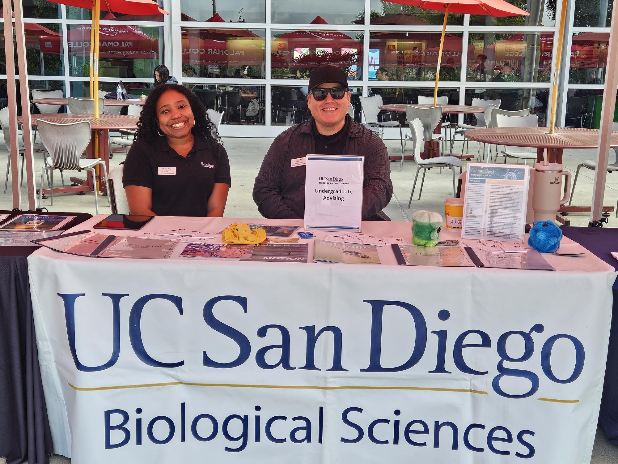 two advisors tabling at an event
