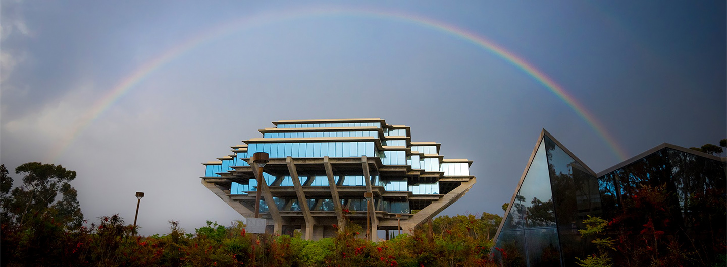 UC San Diego's Geisel Library with a rainbow in the sky behind it